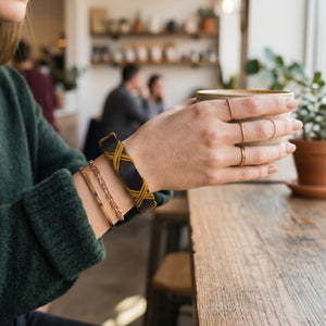 Dark brown and gold bracelet on a wooden surface with text about craftsmanship and style.Handmade leather bracelet with jute weave on a beach setting, featuring text about product features. footy,HAWTHORN HAWKS,football,club,AFL,
#AFL #Footy #AustralianRulesFootball #AFLBracelets #HandmadeJewelry #FootyFans