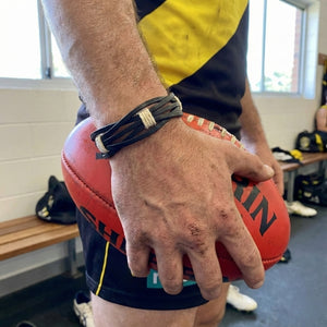 Handmade leather bracelet with jute weave on a beach setting, featuring text about product features. footy,collingwood,football,club,AFL,
#AFL #Footy #AustralianRulesFootball #AFLBracelets #HandmadeJewelry #FootyFans