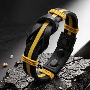 Black and yellow braided leather bracelet on a dark textured surface