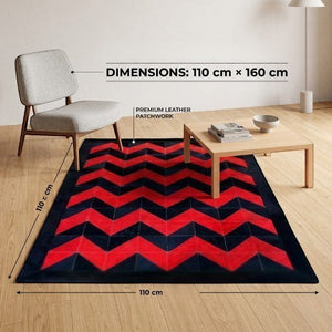 KANDM PARSE LEATHER SHOP geometric chevron patchwork hide rug in black and red, 110x160 cm, in a modern living room.