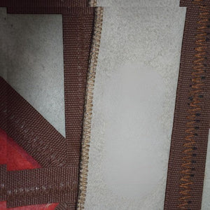 KANDM PARSE LEATHER SHOP handcrafted patchwork rug featuring genuine cowhide and red suede with detailed stitching.