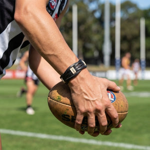 Handmade leather bracelet with jute weave on a beach setting, featuring text about product features. footy,collingwood,football,club,AFL,
#AFL #Footy #AustralianRulesFootball #AFLBracelets #HandmadeJewelry #FootyFans