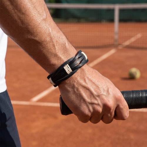 Handmade leather bracelet with jute weave on a beach setting, featuring text about product features. footy,collingwood,football,club,AFL,
#AFL #Footy #AustralianRulesFootball #AFLBracelets #HandmadeJewelry #FootyFans