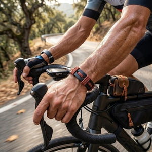KANDM PARSE LEATHER SHOP handmade navy blue and burgundy braided leather bracelet worn by a cyclist on a road bike