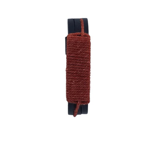 KANDM PARSE LEATHER SHOP handcrafted black leather bracelet with a textured red-brown woven cord wrap.